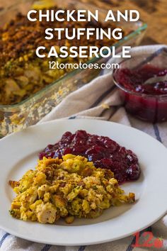 chicken and stuffing casserole on a plate with cranberry sauce in the background