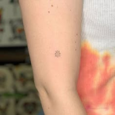 a woman with a small tattoo on her arm