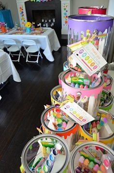 several buckets filled with candy sitting on top of a table