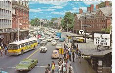 an old postcard shows cars, buses and pedestrians on a busy street in the city