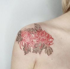 a woman's shoulder with flowers on it