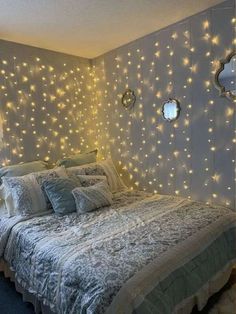 a bedroom with lights on the wall and a bed in it's centerpiece