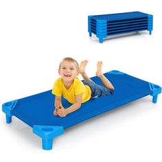 a young boy laying on top of a blue plastic bed with 6 - pack shelves in the background