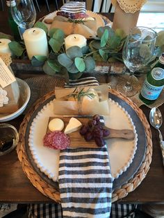 the table is set with wine, cheese and crackers