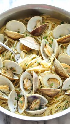 pasta with clams and parmesan cheese in a pan