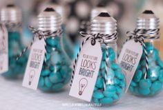 blue candies in glass bottles with tags on them