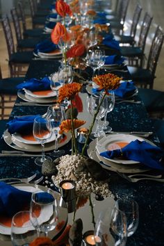 a long table set with blue and orange place settings