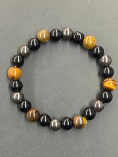 Triple Protection bracelets are handcrafted & designed with 3 of the most powerful protective stones; Obsidian, Tigers Eye & Hematite. Many meditate utilizing the power of these protective stones. In addition, Obsidian coexists with the Root Chakra. Tigers Eye resonates with the Solar Plexus Chakra, Sacral Chakra and the Root Chakra. Hematite corresponds with the Solar Plexus and Root Chakras. *Reminder: This is a unique handcrafted design a (1 of 1) item! CLAIM NOW while supplies LAST! Natural Stone Hematite Beaded Bracelets, Hematite Beaded Bracelets With Natural Stones, Spiritual Hematite Beaded Bracelet With Natural Stones, Obsidian Beaded Bracelets With Natural Stones For Healing, Obsidian Beaded Bracelets For Healing, Healing Hematite Bracelets With Natural Stones, Healing Hematite Bracelet With Natural Stones, Obsidian Beaded Bracelets With Natural Stones, Resin Craft