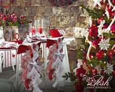 a christmas table setting with red and white decorations