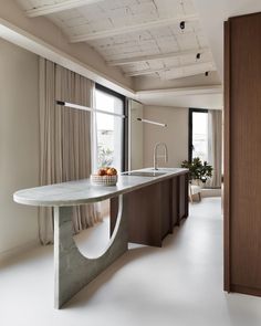 a kitchen with a counter, sink and large window in it's center area