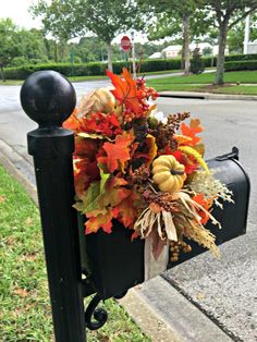 a mailbox decorated with fall leaves and pumpkins