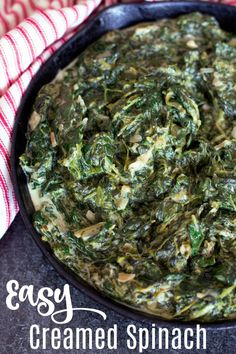 spinach dip in a cast iron skillet on a red and white towel