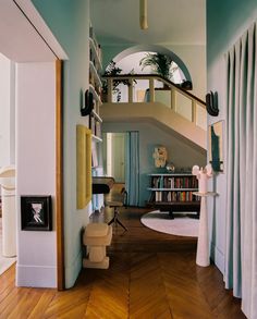 a living room filled with furniture and a spiral staircase