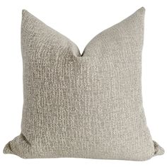 a light gray pillow on a white background