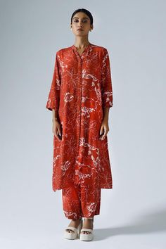 Red long tunic with all-over contrasted abstract floral prints. Comes with co-ordinating midrise pant.
Components: 2
Pattern: Printed
Type Of Work: Abstract Floral
Neckline: Mandarin
Sleeve Type: Three Quarter
Fabric: Crepe
Color: Red
Other Details: 
Pocketed tunic and pant
Length:
Tunic: 44 inches
Sleeves: 17 inches
Pant: 39 inches
Approx. product weight (in gms): 300
Closure:
Kurta: Front concealed buttons
Pant: Zip fly fastening with a single hook fastening on one side
Occasion: Work - Aza Fa Red Floral Print Straight Kurta Set, Red Floral Print Kurta For Spring, Red Summer Palazzo Set With Straight Kurta, Red Long Sleeve Kurta With Floral Print, Red Floral Print Spring Kurta, Red Silk Kurta For Spring, Red Straight Kurta Palazzo Set For Summer, Spring Red Floral Print Kurta, Red Floral Print Palazzo Set With Straight Kurta