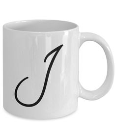 a white coffee mug with the letter j on it