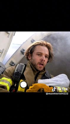 a firefighter is holding something in his hand