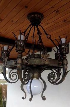 a chandelier hanging from a wooden ceiling