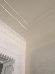 the corner of a room with white paint on the walls