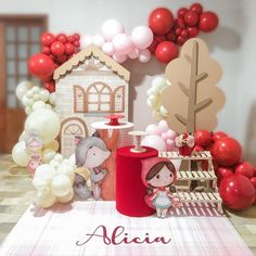 a table topped with balloons and animals next to a house on top of a table