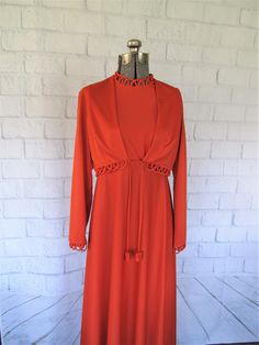 "This is a gorgeous, vintage dress in bright orange.  Color is a very deep red/orange.  Long sleeved maxi dress with matching tie shrug.  Empire waist. In good condition.  Vintage size 16, fit is like a Small.   Measurements are taken with the garment lying flat.  Double them to find your size. Shoulders: 13\"33 cm Bust: 17\"43 cm Waist: 15\"38 cm Hips: 23\"58 cm Length: 53\"135 cm Please be certain before you buy this item because I do not accept returns.  As this is a vintage item, I do not kn Bright Orange Dress, Sleeved Maxi Dress, Orange Maxi Dress, Vintage Orange, Scalloped Lace, Orange Dress, Vintage Dress, Bright Orange, Long Sleeve Maxi Dress