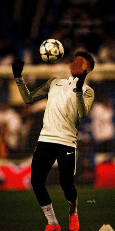 a soccer player in the air with a ball on his head and one hand up