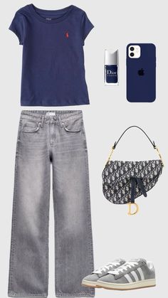 a woman's outfit including jeans, sneakers and an iphone case is seen in this image