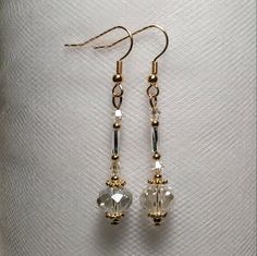 These are long unique genie or perfume bottle style earrings. they are made with crystal glass beads and silver and gold pated metal accents. These ae light long and flirty and would go with any out fit for any occasion! We can make these in almost any color so if you cant find it made on our page please put in a custom request!These would make a unique addition to anyone's jewelry collection and great gifts for friends and family! Handmade Elegant Crystal Earrings For Festive Occasions, Elegant Handmade Crystal Earrings For Festive Occasions, Gold Czech Glass Beaded Earrings For Party, Gold Crystal Beaded Dangle Earrings, Handmade Gold Crystal Earrings For Festive Occasions, Gold Crystal Earrings With Dangling Beads For Wedding, Festive Handmade Gold Crystal Earrings, Elegant Gold Beaded Earrings With Faceted Beads, Elegant Party Jewelry In Czech Glass