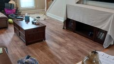 a living room filled with furniture and a flat screen tv on top of a wooden table