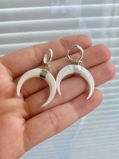 These earrings are silver Plated huggie hoops. They have these white crescent horn charms hanging down and are light weight and easy on the ears! White Sterling Silver Pierced Huggie Earrings, Nickel Free White Sterling Silver Huggie Earrings, Nickel-free White Sterling Silver Huggie Earrings, Small Hoop White Cartilage Earrings For Gift, Sterling Silver White Cartilage Earrings With Ear Wire, White Sterling Silver Cartilage Earrings, White Nickel-free Huggie Hoop Earrings, White Dangle Cartilage Earrings, White Sterling Silver Drop Cartilage Earrings