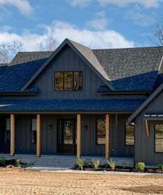 a house with blue shingles on the roof