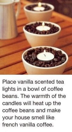 three white bowls filled with coffee beans on top of a wooden table next to a tea light candle