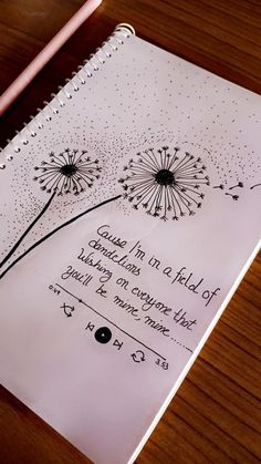 a notepad with a dandelion drawing on it next to a pink pencil