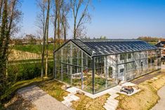 an aerial view of a glass house in the countryside