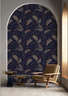 a chair and table in front of a blue wall with birds on it, next to an arched doorway