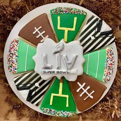 a decorated cake with the words live on it and footballs in different colors, shapes and sizes