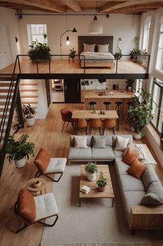 an overhead view of a living room with couches, tables and stairs in it