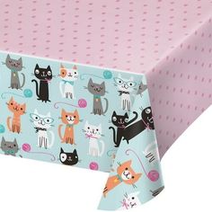 a pink tablecloth with cats on it and polka dotty dots in the background