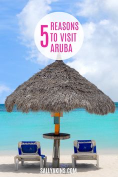 two chairs under an umbrella on the beach with text reading 5 reasons to visit aruba