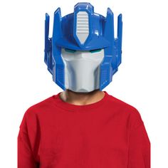 a young boy wearing a blue and white mask on top of his head in front of a white background