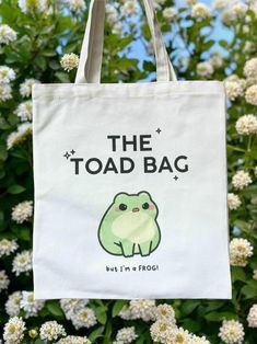 the toad bag is hanging in front of some white flowers