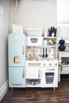 a play kitchen with blue and white appliances