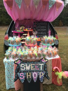 the trunk of a car is filled with candy and candies for sweet shoppers