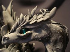 a statue of a dragon with green eyes