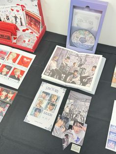 the table is covered with various items from different countries, including dvd's and cds