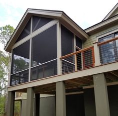 a large house with two balconies on the second floor and an attached balcony