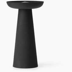 a black vase sitting on top of a table