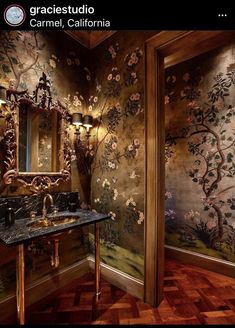 an ornate bathroom with wallpaper and mirror