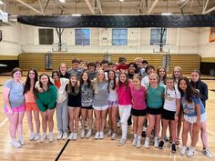 a group of young people standing next to each other on a basketball court