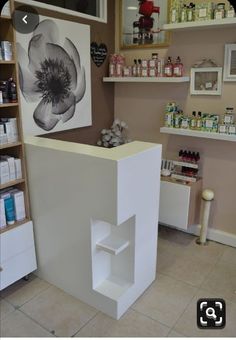 the inside of a beauty salon with shelves and bottles on the wall, including an open door